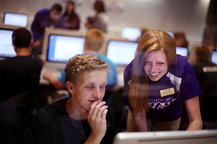 Students work together on a computer.